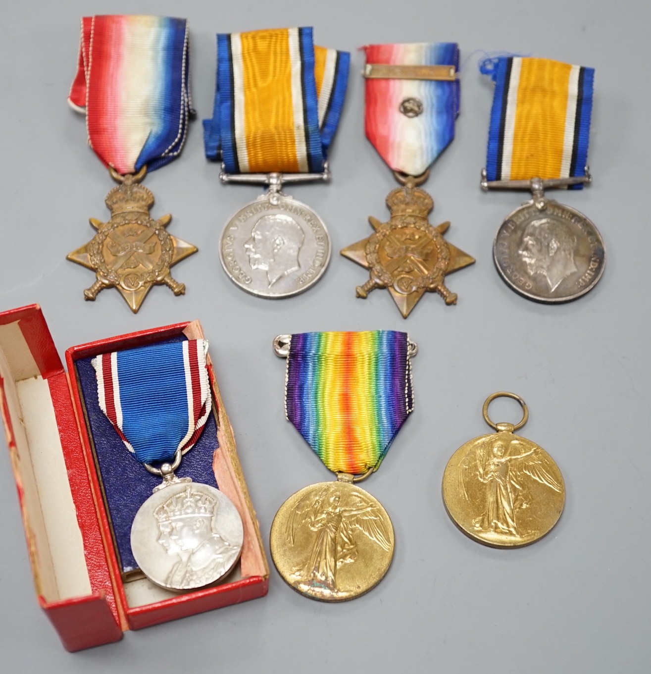 WWI and later medals - Mons star (with bar and rosette) trio to 6480 PTE. F. TURNER 1/DNS., a Mons star pair to L-8608 CPL. E.T. DYER. 1/R W. KENT R., an unnamed Great War medal and a boxed George VI coronation medal (7)